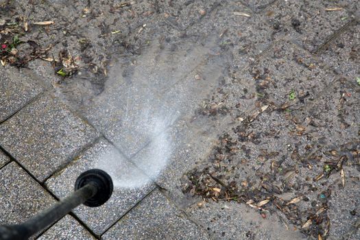 Outdoor floor cleaning with high pressure water jet