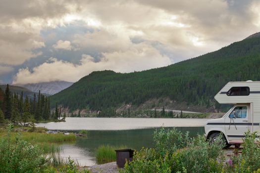 Camper van parked on Summit Lake Campground in Stone Mountain Provincial Park, highest point of the Alaska Highway, northern BC, Canada