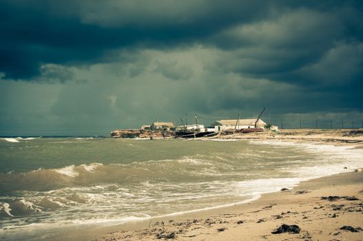 Art toned image of  fisherman shack with stormy skies. Crimea.