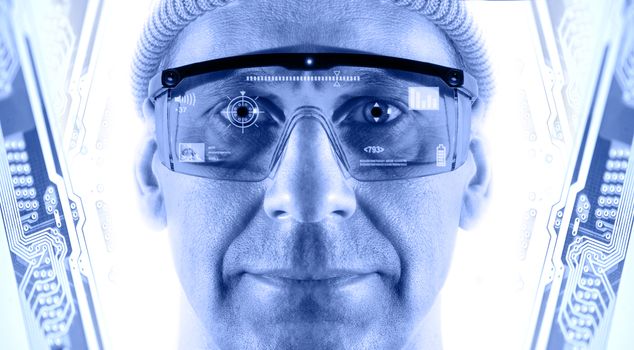 Portrait of men in smart glasses on a electronic circuit board background. Toned blue.