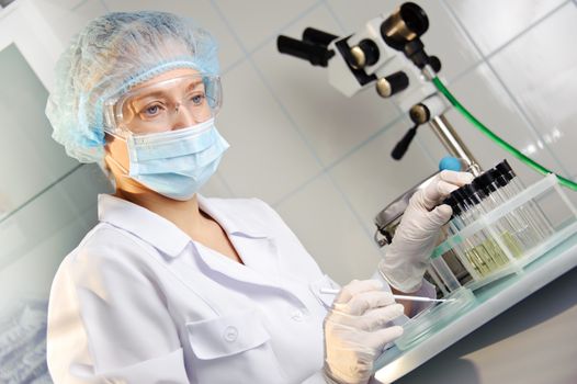 A female doctor examines a sample. 
Could be useful for medicine, hospital, research and development, clinical studies, forensics, science etc