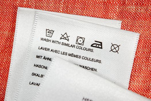 Clothing label washing instruction tag. Close up.