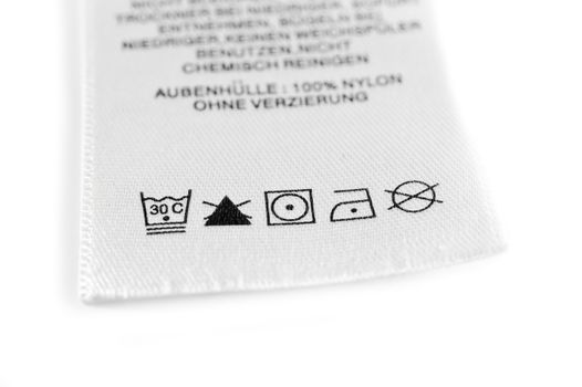 Close up view on an isolated washing label tag.