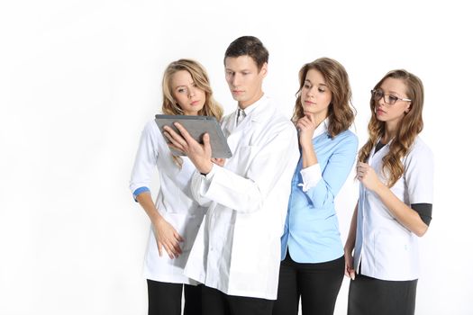 Four young attractive doctors in white, blue aprons on a white background