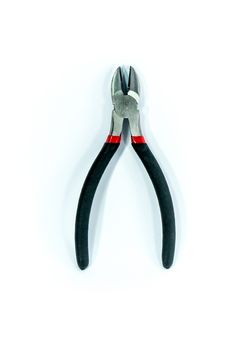 metal pliers on white scene,shallow focus