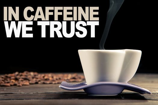 close up of a steaming cup of coffee with coffee beans scattered behind on a wooden table and a black background. file with text for print use