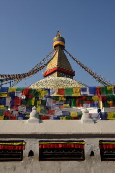 Buddhist Shrine Boudhanath Stupa with pray flags over blue sky. Nepal, Kathmandu