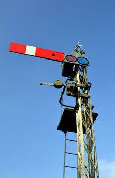 Rural British railway signal in stop position.