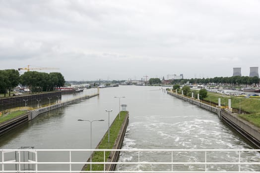view from the maas river sluice at the city skyline maasbracht in holland