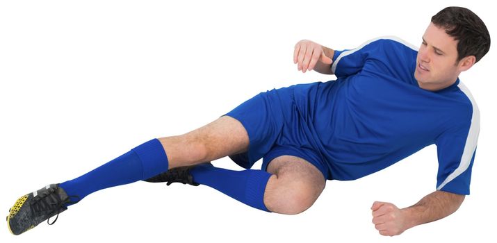 Football player in blue kicking on white background