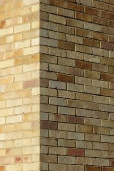 Edge between two light brick walls, one sunlit, one shaded