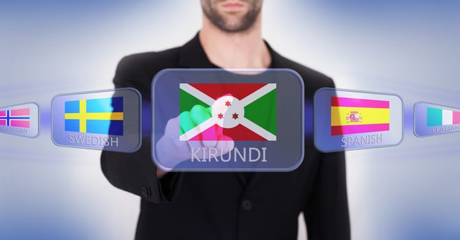 Hand pushing on a touch screen interface, choosing language or country, Burundi