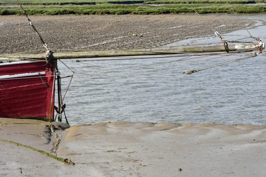 Bow of red boat with anchor