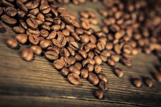 close up of coffee beans on a wooden table