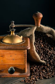 jute bag full of coffee beans and old grinder