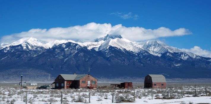 View of the Colorado winter with litter house and Rocky mountain as background.