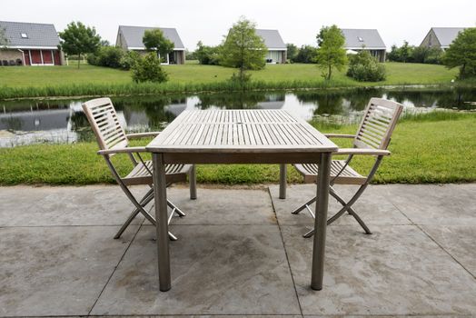 wooden chairs and table to relax on holiday near the water
