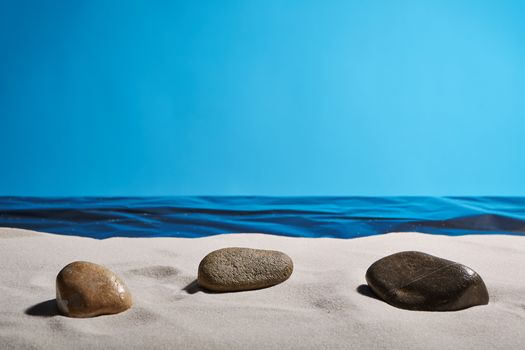 three stones on a clean beach to find the peace of mind