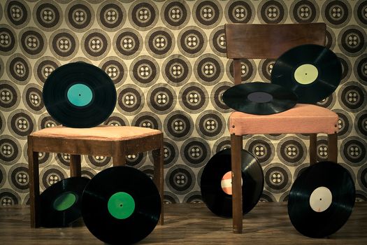 retro room full with 33rpm discs on chair and footrest