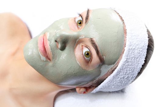 woman relaxes in the mask with green clay