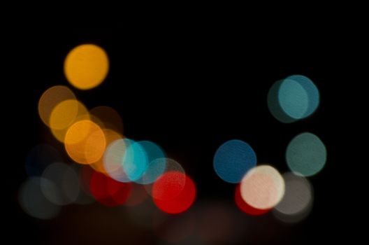 Out of focus lights of a public street during night time