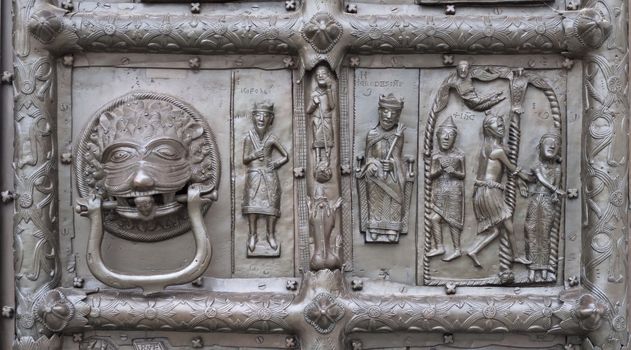 Door knocker of ancient bronze gates of Magdeburg in Veliky Novgorod, Russia. Fragment of bas-relief