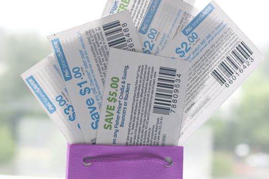 Coquitlam, BC, Canada - May 25, 2014 : Close up coupons inside gift bag. All coupons for Canadian store, they are issued by manufacturers of consumer packaged goods or by retailers in Canada.