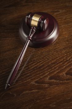 Dark Wooden Gavel Abstract on Table with Room for Text.