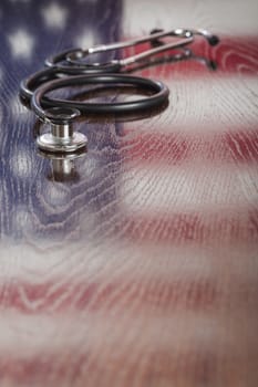 Stethoscope with American Flag Reflection on Wooden Table.