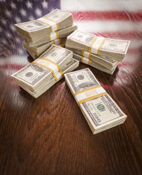 Thousands of Dollars Stacked with Reflection of American Flag on Wooden Table.