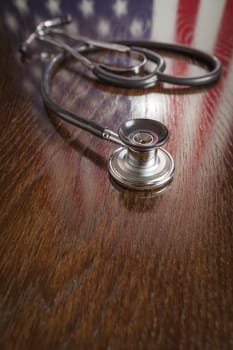 Stethoscope with American Flag Reflection on Wooden Table.
