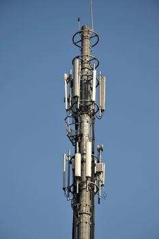 typical communication tower in telecommunication industry againts blue sky