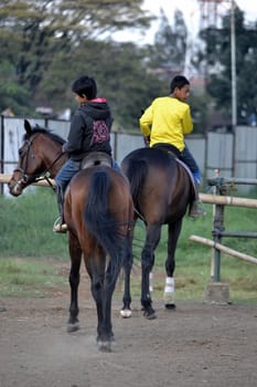 bandung, indonesia-may 31, 2014-young boy learn to riding a horse in arcamanik horse race arena