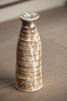 Traditional handcrafted vase of brown color on the table