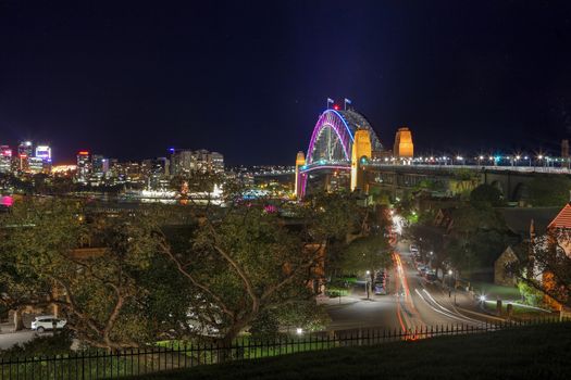SYDNEY, NSW, AUSTRALIA - JUNE 3, 2014;  Sydney Harbour Bridge during Vivid Sydney from Observatory Hill.  View North across the harbour to North Sydney.  Long 32sec exposure with some motion in stars and cars on Lower Fort Street