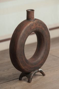 Traditional handcrafted vase of brown color on the table