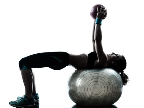 one caucasian woman exercising fitness ball workout posture in silhouette studio isolated on white background