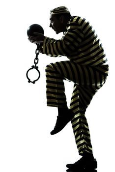 one caucasian man prisoner criminal escaping with chain ball silhouette in studio isolated on white background