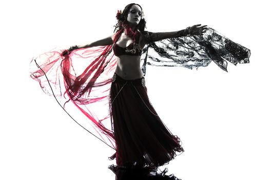 one arabic woman belly dancer dancing silhouette studio isolated on white background