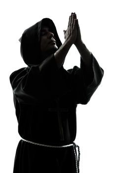 one caucasian man priest praying silhouette in studio isolated on white background