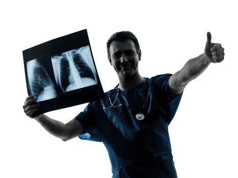 one caucasian man doctor surgeon radiologist medical thumb up examining lung torso x-ray image silhouette isolated on white background