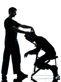 two men performing chair back massage in silhouette studio on white background