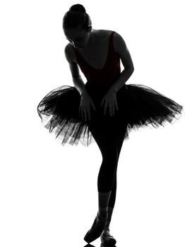 one caucasian young woman ballerina ballet dancer dancing with tutu in silhouette studio on white background