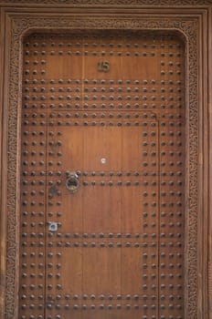 Studded wooden door to a historic Riad in the ancient city of Fes in Morocco, North Africa