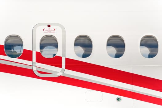 emergency exit doorway on the fuselage of a passenger aircraft