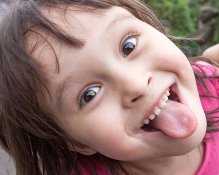 Child making funny face and sticking tongue out