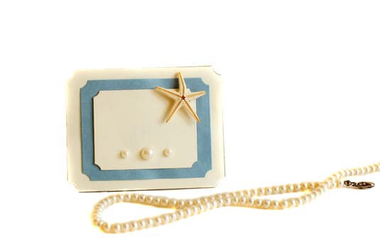Blue and white card with a sea star and pearls                               