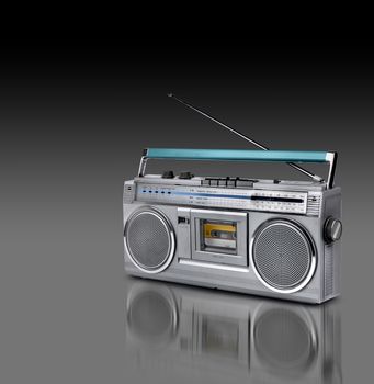 Vintage stereo radio cassette player of 80s dark background
