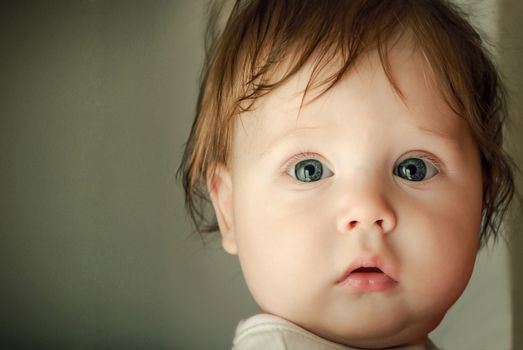 Face closeup the little baby with beauty eyes. Soft focus