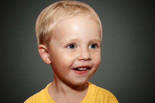 Face little boy on the gray background.